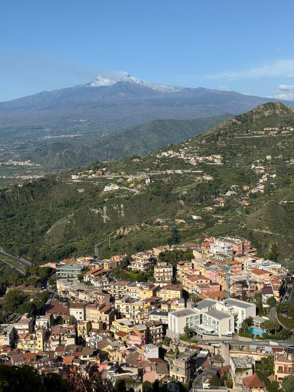 Mynd af bænum Taormina með Etna í bakgrunni